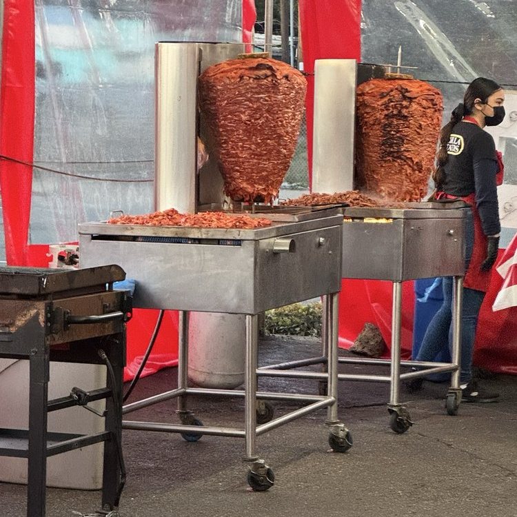 Al pastor and adobada being carved off the trompo at Chula Tacos