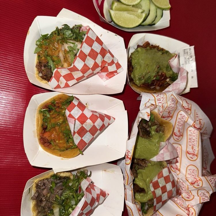 A spread of Tijuana style tacos with lime at Chula Tacos
