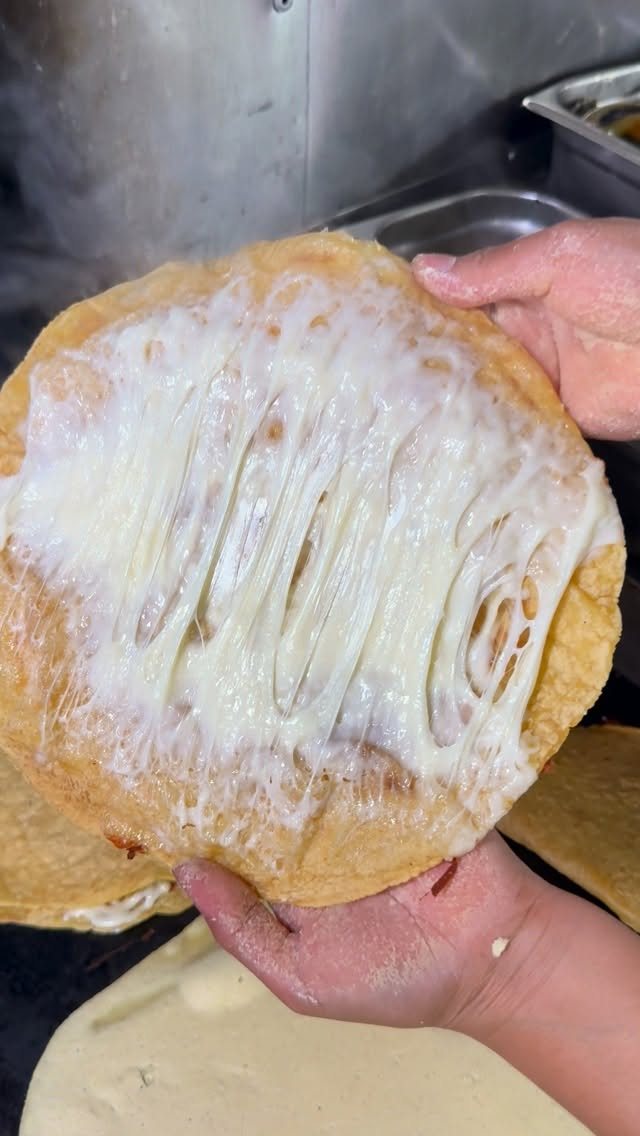 Handmade corn tortillas puffing on the comal at Chula Tacos